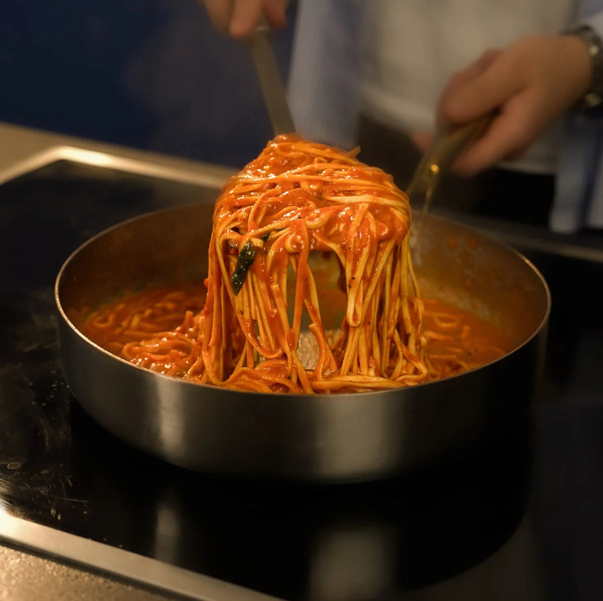 Spaghetti à la sauce tomate soulevés d'une poêle profonde en titane Maison Ferré®